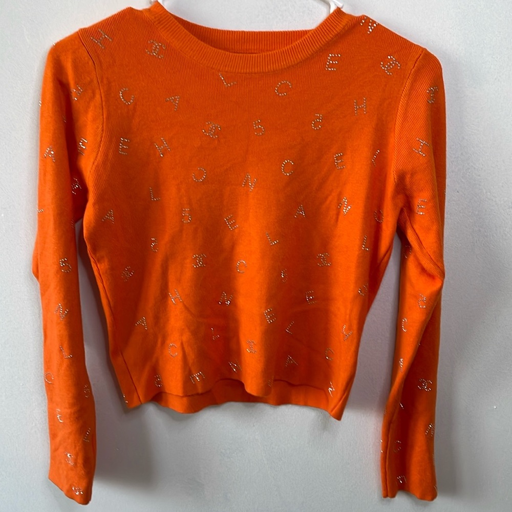 Orange sweater with rhinestones